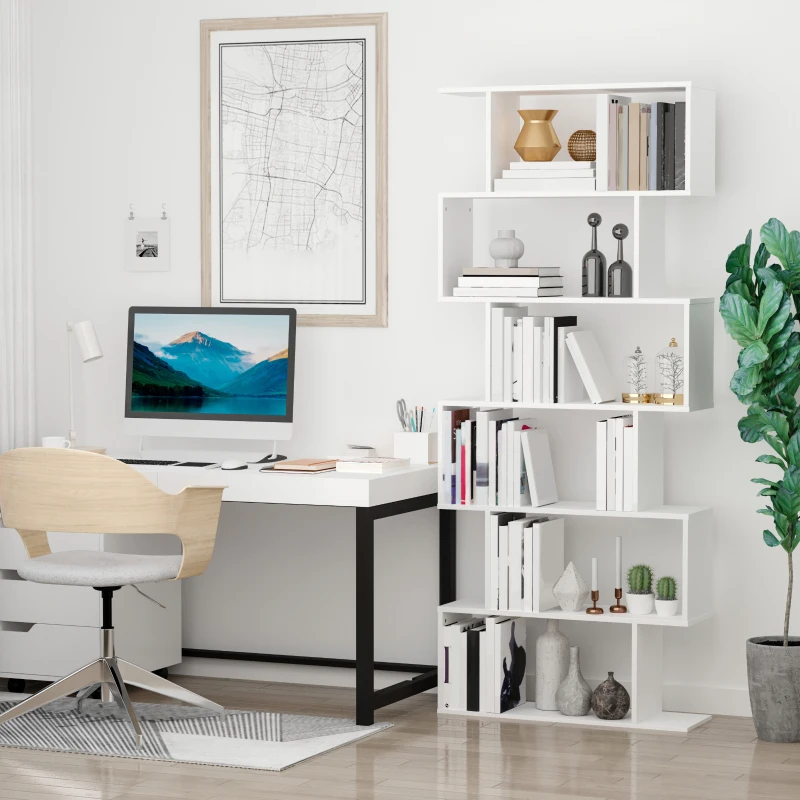 White S-shaped bookcase with staggered shelves displaying books, vases, and décor beside a home office desk.
