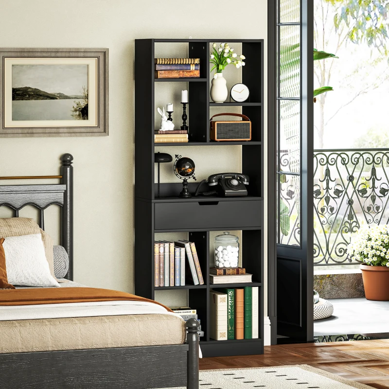 Black modern bookshelf beside bed near balcony, filled with books and décor accessories.