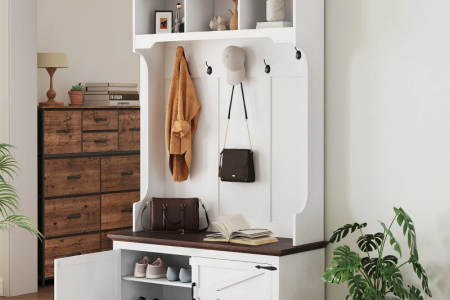 Stylish entryway with white hall tree, hooks, storage bench, shoe rack, and cabinet.
