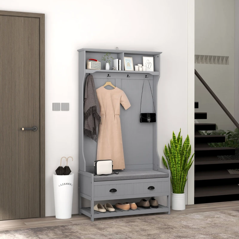 Gray hall tree with cushioned bench, drawers, hooks, and open shoe storage in entryway.