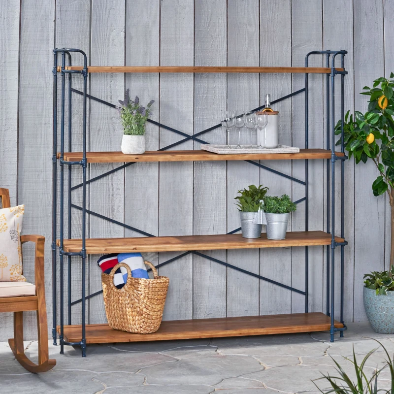 Industrial-style metal frame bookcase with wooden shelves, decorated with plants, basket, and glassware.