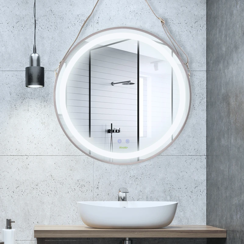Round LED bathroom mirror with built-in lighting hanging above white basin and gray wall.
