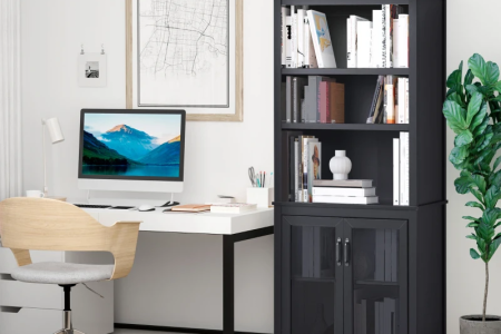 Black bookcase beside white desk and chair in a modern home office.