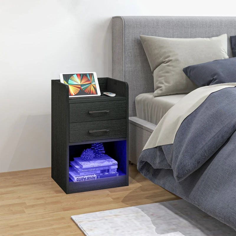 Black bedside table with drawers, open shelf, LED lights, books, and tablet charging station.