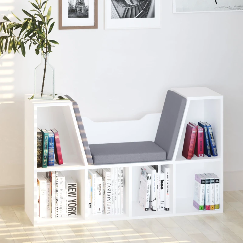 White cubby bookcase with built-in cushioned seat, storing books and décor items neatly.