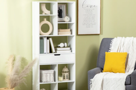 White bookshelf styled with books and home accessories.