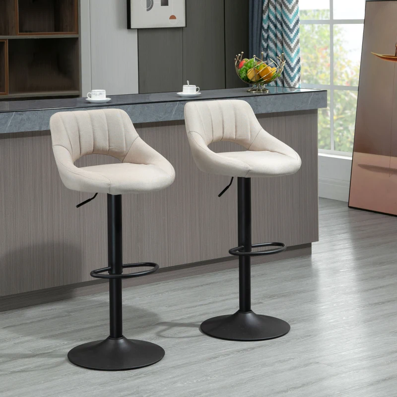 Modern beige upholstered bar stools with curved backs in kitchen