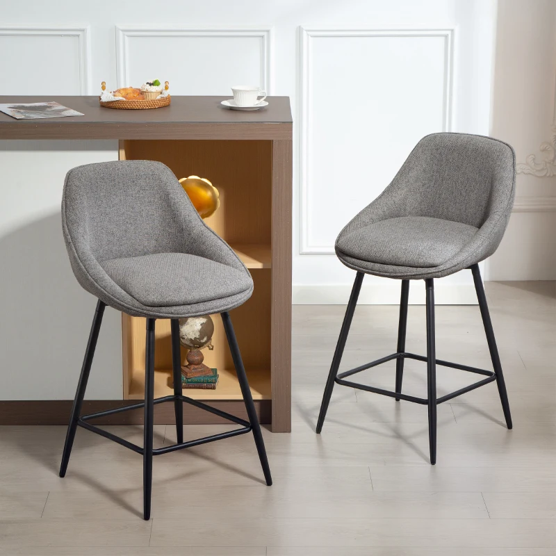 Gray upholstered bar stools with armrests and wooden legs