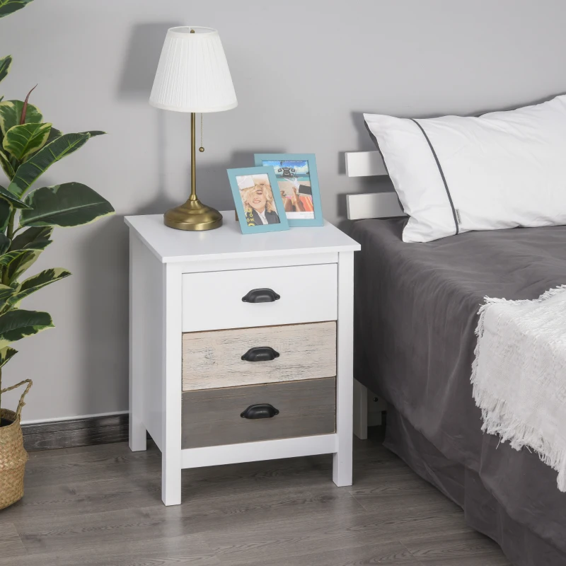 White bedside table with lamp, books, and photo frames in modern bedroom.