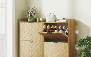 Wooden shoe cabinet with chevron doors and decorative vase.