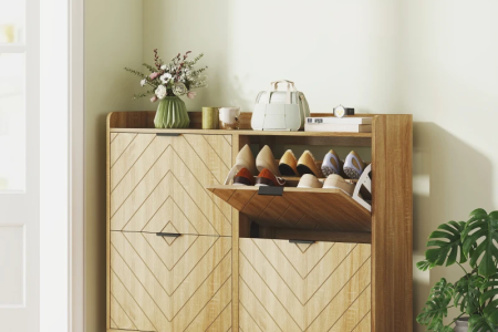 Wooden shoe cabinet with chevron doors and decorative vase.