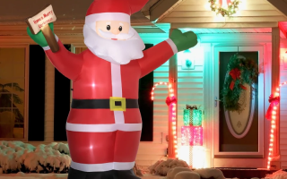 Inflatable Santa Claus decoration displayed outdoors with festive lights