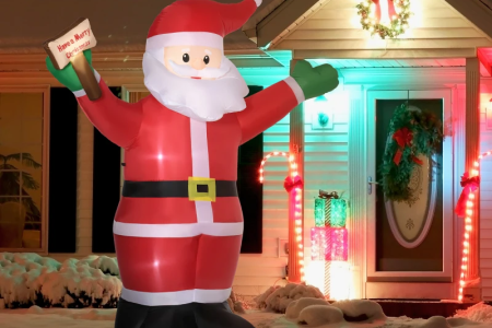 Inflatable Santa Claus decoration displayed outdoors with festive lights
