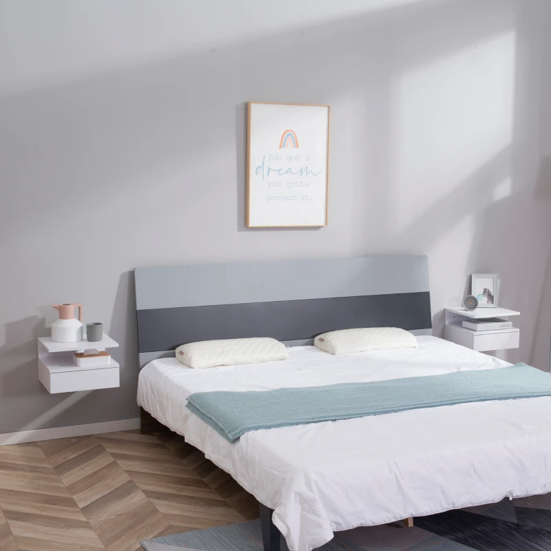 Minimalist bedroom with wall-mounted white bedside tables on both sides of bed.
