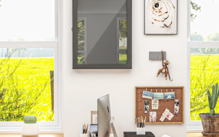 Modern home office wall with empty shadow box above desk.
