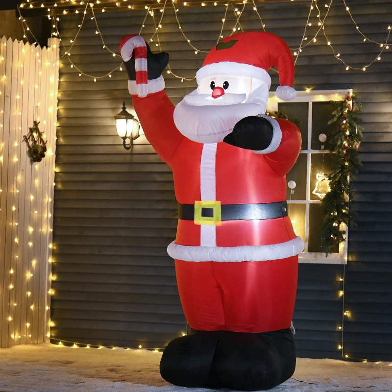 Inflatable Santa Claus holding candy cane outside house with festive lights.