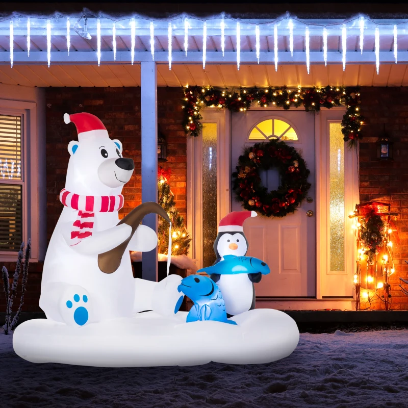 Inflatable polar bear with penguin and fish display on snowy porch.