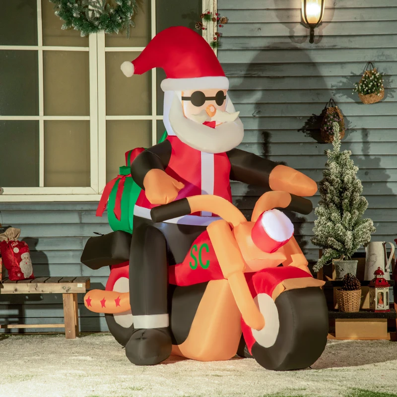 Inflatable Santa Claus riding motorcycle with gift bag outdoors.