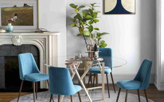 Glass round dining table with blue upholstered chairs