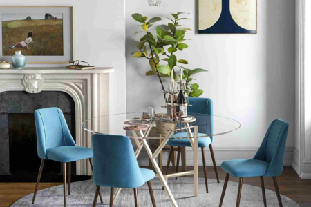 Glass round dining table with blue upholstered chairs