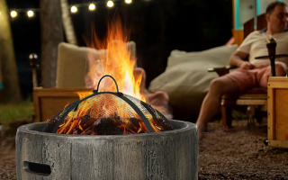 Stone fire pit burning brightly with chairs placed around