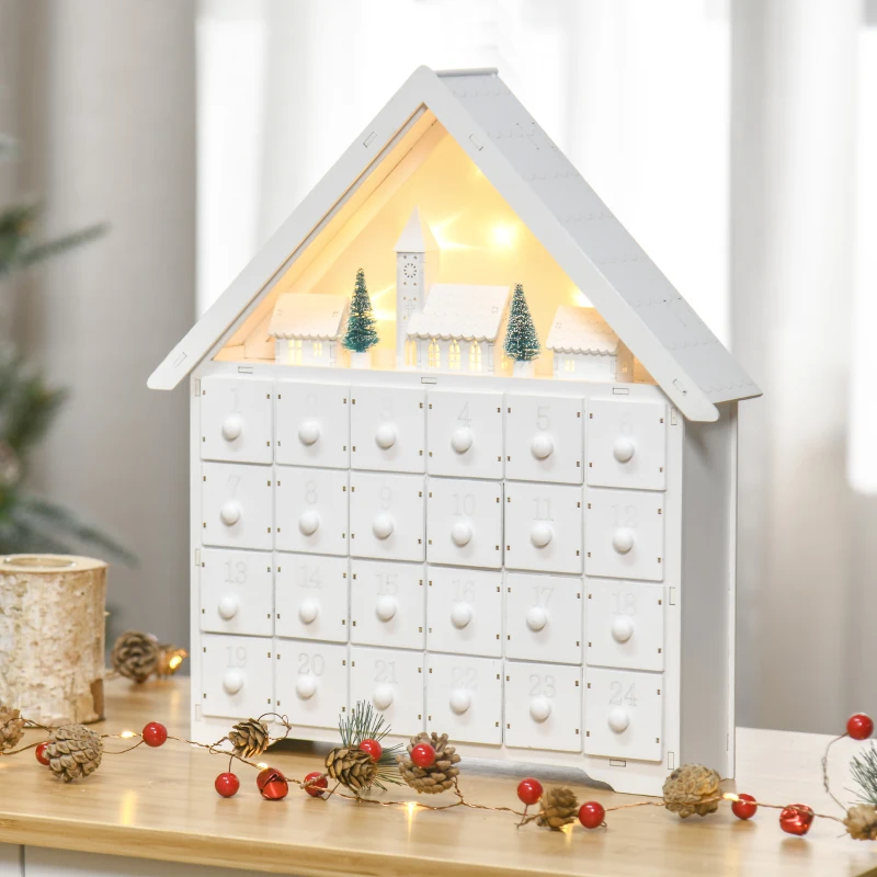 White house-shaped advent calendar with glowing village scene.