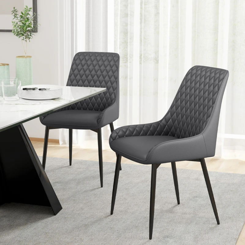 Elegant upholstered diamond-tuft chairs with black metal legs.