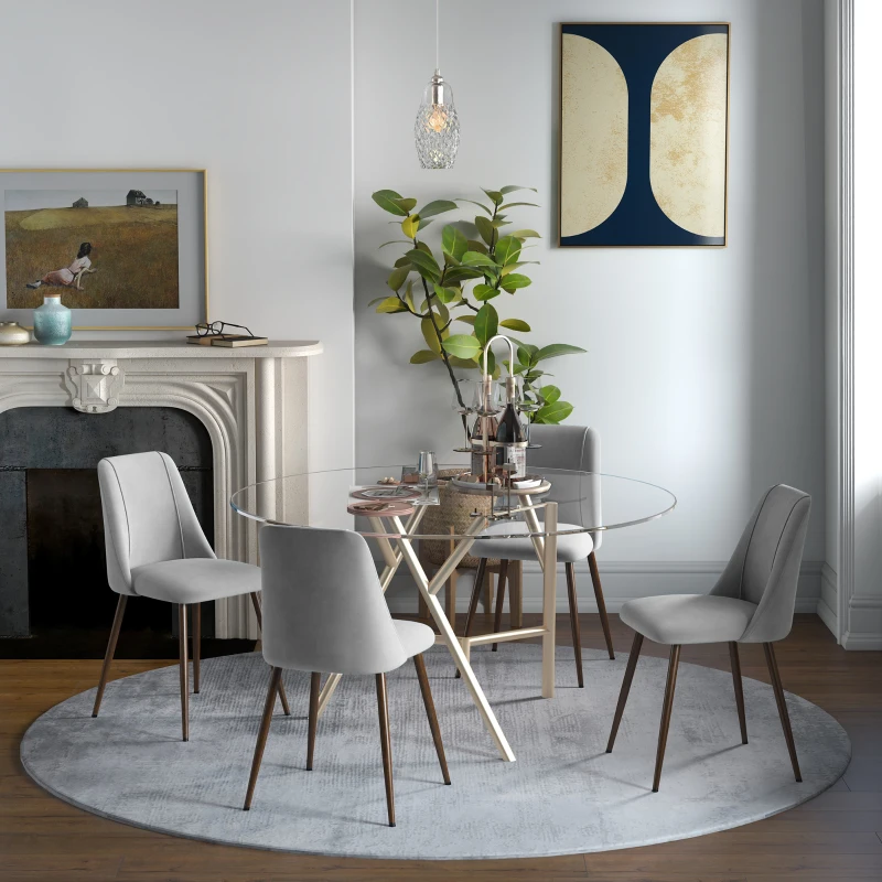 Soft velvet quilted dining chairs around round glass dining table.