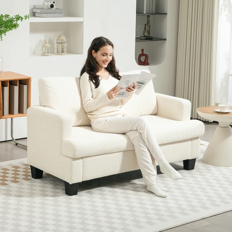 Cozy two-seater sofa with soft fabric upholstery in living space.