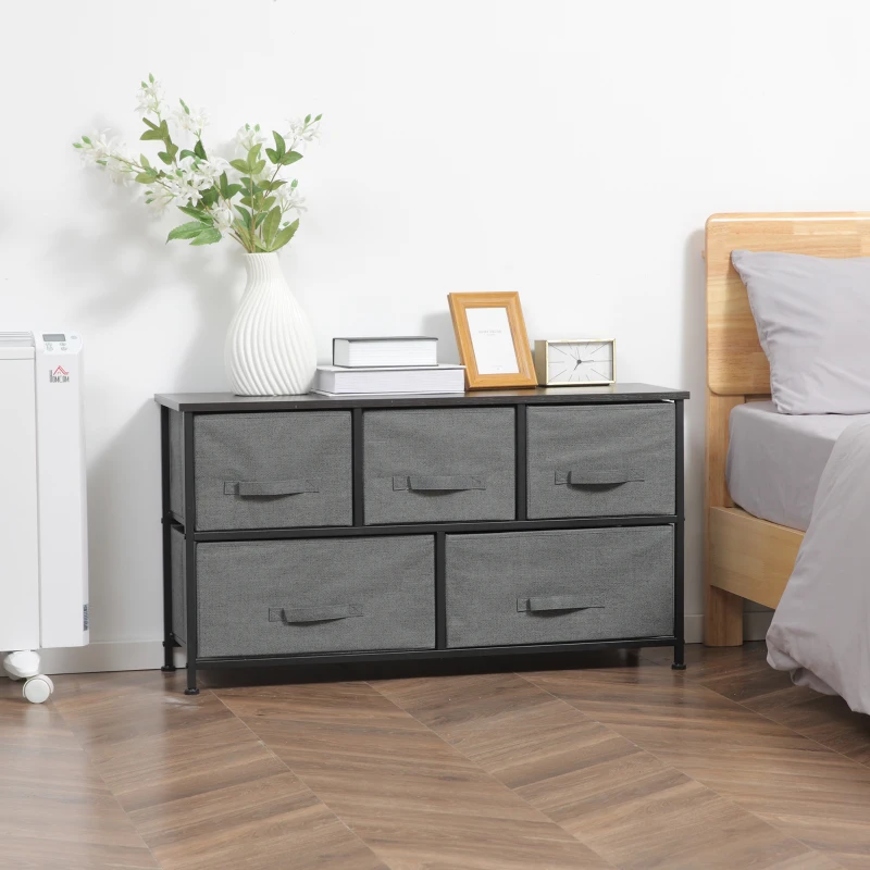 Black fabric drawer dresser with tabletop decor in bedroom.