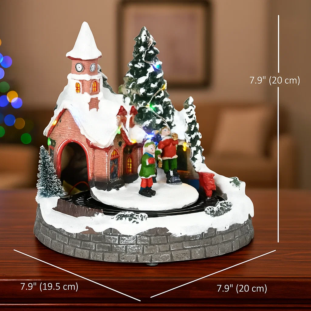 Miniature Christmas village house with figures, snow, and lit tree.