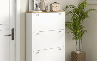 White shoe cabinet with three flip drawers in hallway.