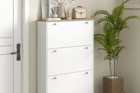 White shoe cabinet with three flip drawers in hallway.