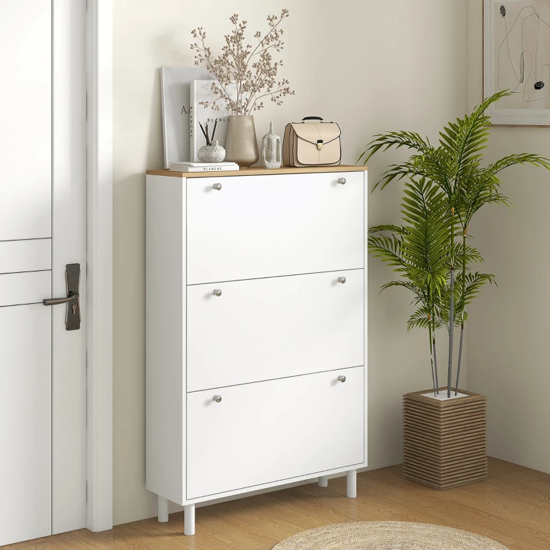 White shoe cabinet with three flip drawers in hallway.