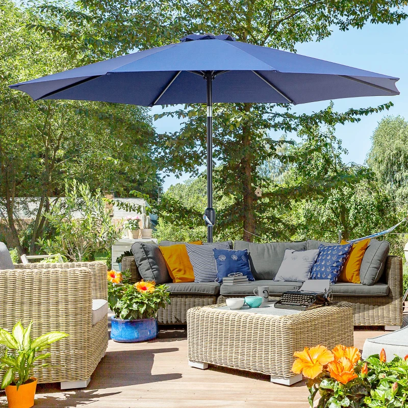 Blue patio umbrella shading wicker sofa set with cushions.
