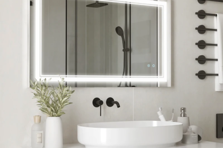 Modern LED bathroom mirror above sink and vanity.