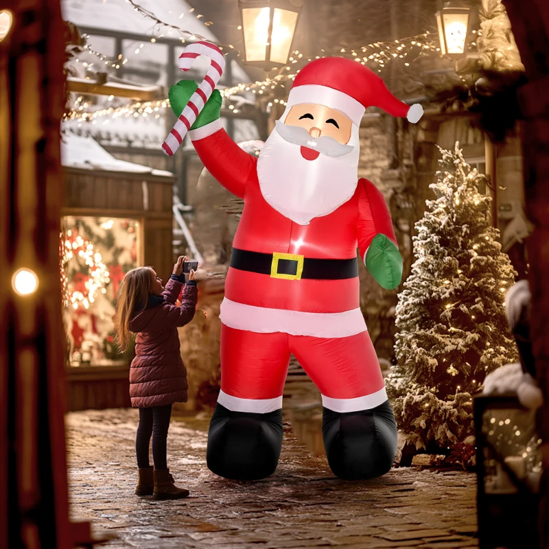 Giant inflatable Santa Claus holding candy cane in yard.