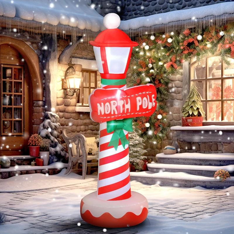 Inflatable candy-striped North Pole lighthouse decoration glowing outdoors.