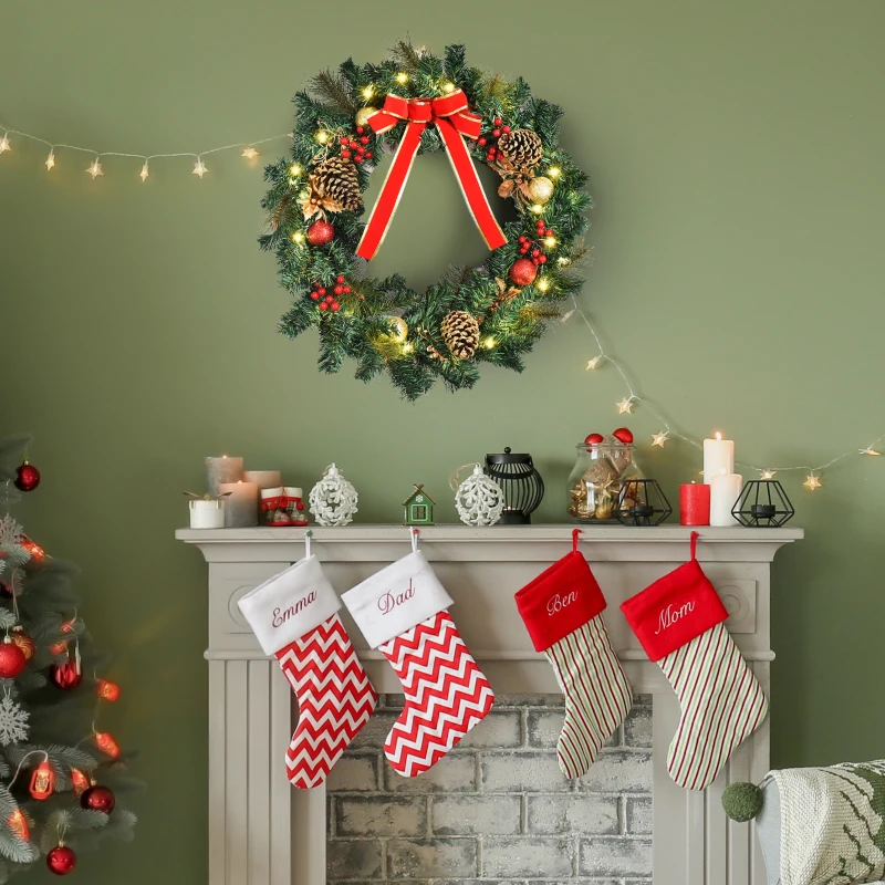 Lighted spruce wreath with red bow hanging above fireplace.
