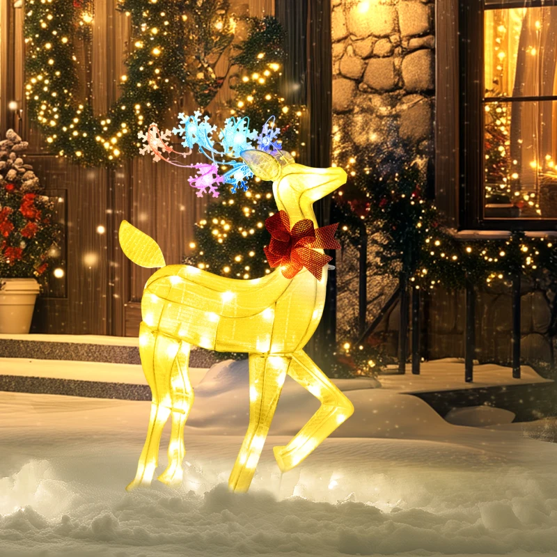 Outdoor golden lighted reindeer with red bow in snow.