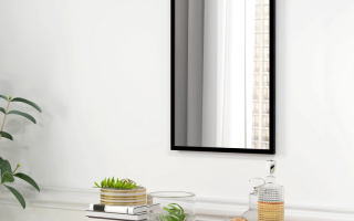 Modern black framed mirror hanging above wooden dresser.