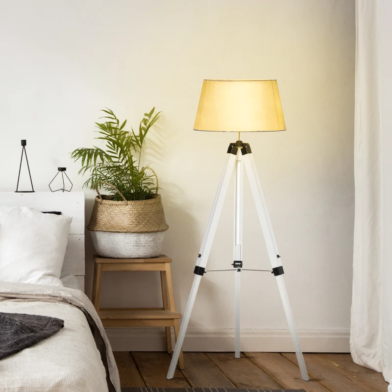Cozy bedroom corner with tripod floor lamp and potted plant