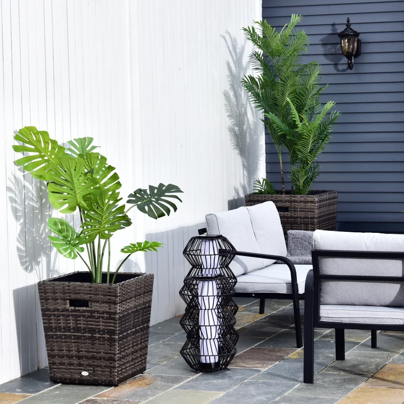 Outdoor seating area with wicker planters and green plants