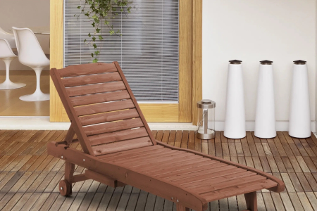 Finished wooden lounge chair placed on patio deck.