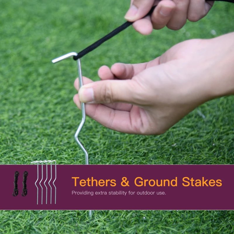 Hand securing Halloween inflatable with ground stake and tether.