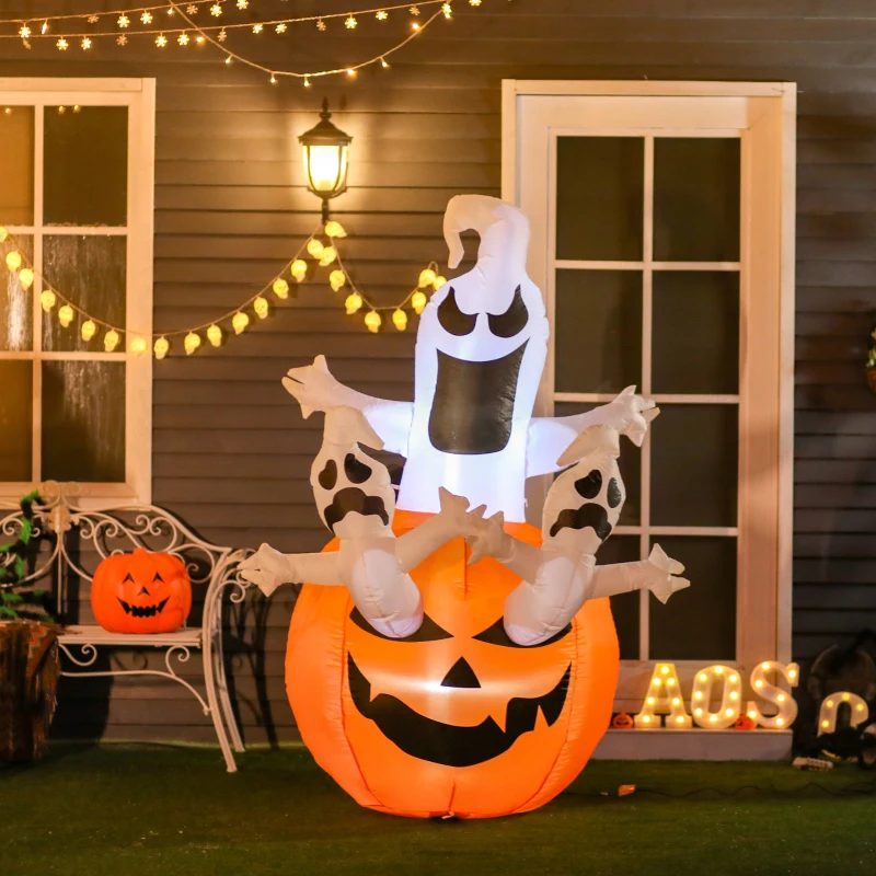 Lighted Halloween inflatable ghost rising from jack-o-lantern outdoors.