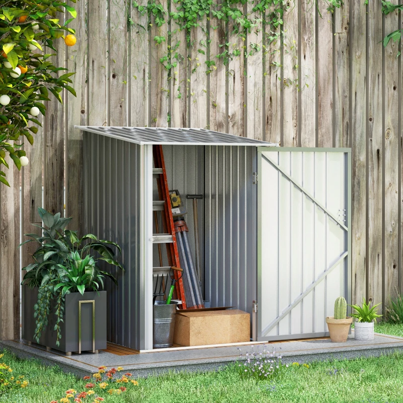 Compact lean-to shed against fence storing ladder, tools, and gardening items.