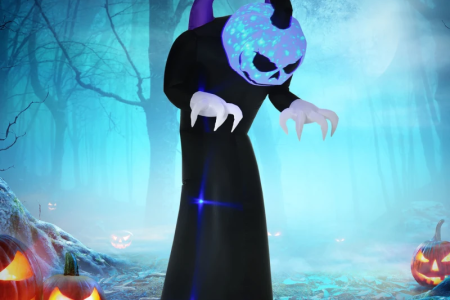 Creepy inflatable pumpkin-headed monster with glowing blue face in spooky forest.