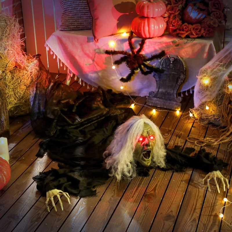 Creepy crawling zombie with glowing eyes on wooden floor surrounded by pumpkins.