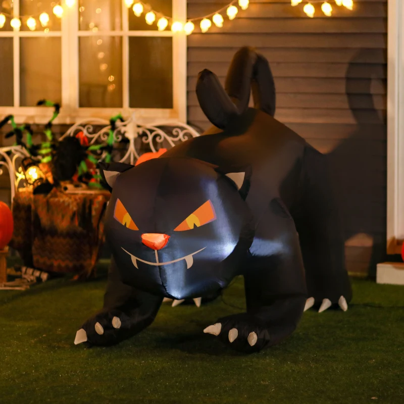 Inflatable black cat with glowing eyes displayed on porch with pumpkins.